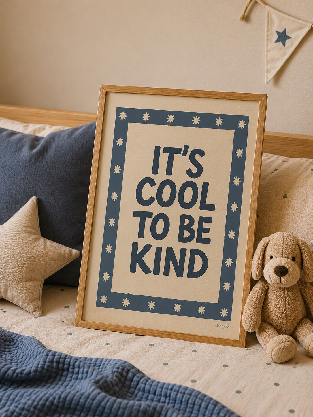 It's Cool to Be Kind statement poster styled on a cozy children's bed